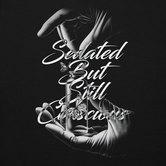 Gloved hands releasing a butterfly in a vial – symbolic black-and-white design on hoodie for alt nurses.